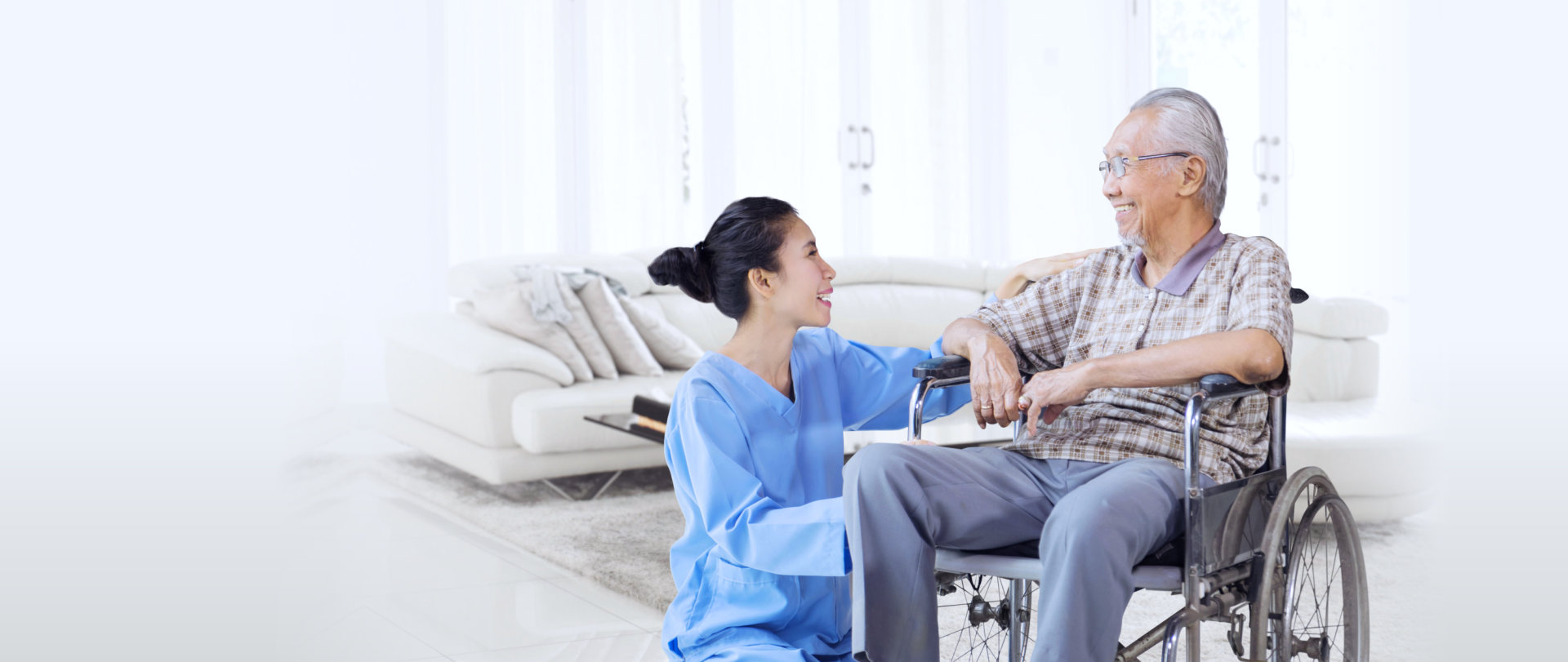 nurse talking with a senior in wheelchair