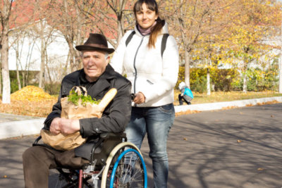 caregiver assisting an old man